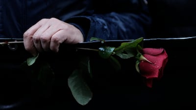 A Kurdish activist holds a rose during a march to honour three women Kurdish activists who were shot dead in 2013, Monday, Dec 26, 2022 in Paris. A 69-year-old Frenchman is facing preliminary charges of racially motivated murder, attempted murder and weapons violations over last Friday's shooting, prosecutors said. AP