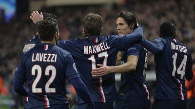 Edinson Cavani, second right, is congratulated by teammates after pulling PSG level. Miguel Medina / AFP