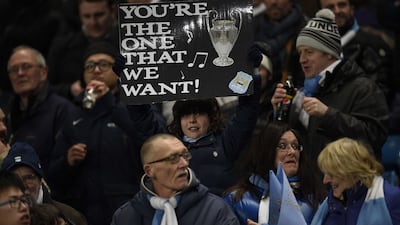 A Manchester City fan holds up a sign as they wait for kick off at Tuesday night's Champions League last 16 match against Barcelona. Lluis Gene / AFP