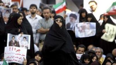 Thousands of people attend a state-organised rally in a square in central Tehran.
