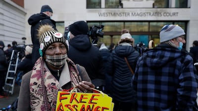 A Julian Assange supporter holds up a placard outside Westminster Magistrates Court. AP Photo