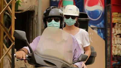 Lebanese motorists wear dust masks to protect themselves during their commute in Beirut. Joseph Eid / AFP Photo