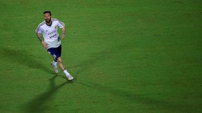 Messi enjoys a run during training. EPA