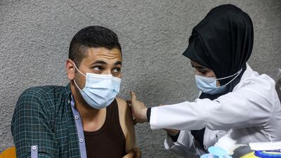 A nurse gives a dose of the Pfizer-BioNTech coronavirus vaccine to a patient at Kindi Hospital in Baghdad. AFP
