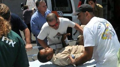 An injured Israeli soldier is brought into Yosseftal hospital in the Red Sea resort of Eilat after an ambush on a bus north of town last month which prompted a controversial blog from Larry Derfner. Yehuda Ben Itah / AFP Photo