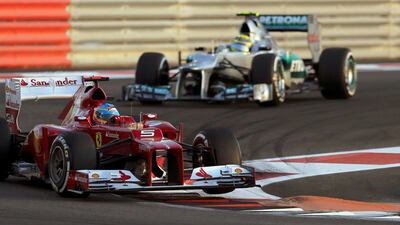 Ferrari's Fernando Alonso of Spain ahead of Mercedes driver Nico Rosberg during the qualifying session of the Abu Dhabi F1 Grand Prix Ahmed Jadallah/Reuters