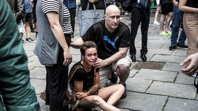 A woman is comforted in front of the mall. Police received the first reports of a shooting at 5.37pm on Sunday, and arrested the suspect 11 minutes later. Reuters