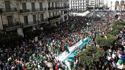 Demonstrators carry banners and flags during a protest demanding the removal of the ruling elite and prosecution of former officials linked to former President Abdelaziz Bouteflika, in Algiers, Algeria June 14, 2019. Reuters