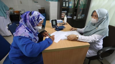 A pilgrim Banda Aceh, Indonesia, registers for a vaccination required to undertake the Hajj. EPA