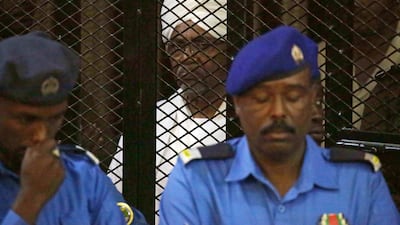 Sudan's ousted president Omar Al Bashir sits in the defendant's cage during his trial in Khartoum. EPA