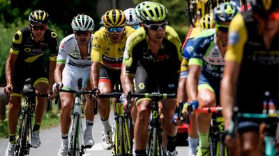 Belgium's Greg van Avermaet, third from left, wearing the overall leader's yellow jersey, rides in a breakaway group during the 10th stage of the Tour de France between Annecy and Le Grand-Bornand. Jeff Pachoud / AFP