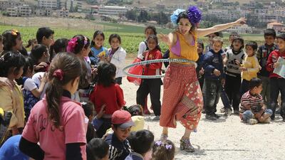 Members of Clowns Without Borders entertain Syrian refugee children in Jab Janine, Lebanon, on June 2. Sharif Karim / Reuters