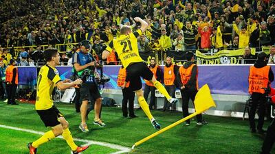 Borussia Dortmund’s Andre Schurrle, right, celebrates with his teammate Christian Pulisic, left, after scoring the equaliser. Ina Fassbender / EPA