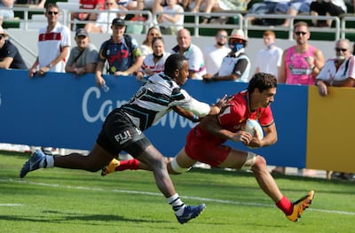 Players in action during the match between Fiji (black & White) vs Spain (red) on the second day of the Emirates Dubai Rugby Sevens. Pawan Singh/The National.