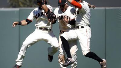 San Francisco Giants’ Angel Pagan, left, Gregor Blanco, centre, and Hunter Pence, right, celebrate after a victory over the Washington Nationals in a baseball game in San Francisco. Tony Avelar / AP