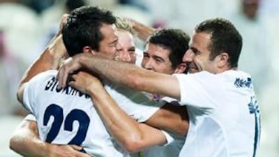 Adam Dickinson, number 22, of Auckland City, celebrates with his team mates after scoring the first goal.
