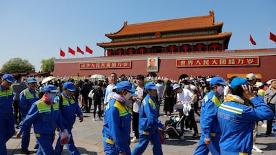 Chinese street cleaners walk in front of the Tiananmen Gate in Beijing, China. EPA