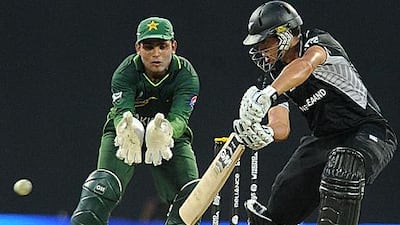 Kamran Akmal, the Pakistan wicketkeeper, left, watches Ross Taylor score more runs on his way his century in New Zealand's 110-run win.