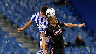 Martin Odegaard challenges for a header against Real Sociedad's Robin Le Normand. AP Photo