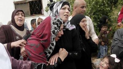The mother (second from left) of Naji Balbisi, a 19-year-old Palestinian shot by Israeli troops, mourns with other relatives during his funeral in the West Bank town of Anabta.