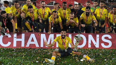 Al Ahed's players and coaching staff celebrate with the trophy after winning the 2019 AFC Cup Final with victory over North Korea's April 25 Sports Club at Kuala Lumpur Stadium. AFP