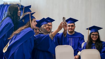 Students take photos before the Mohamed bin Zayed University of Artificial Intelligence's first graduation ceremony, in Abu Dhabi. The UAE’s development of a competitive education system is a continuing process. Khushnum Bhandari / The National