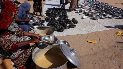 Refugees from El Fasher, displaced by the war between the RSF and the Sudanese army, receive meals at a camp in Tine, Chad. Reuters