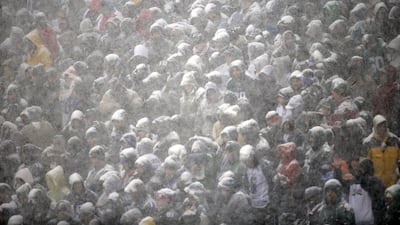 Fans huddle together, covered in snow, in Philadelphia. Matt Rourke / AP