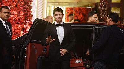 US musician Nick Jonas waves as he arrives. AFP