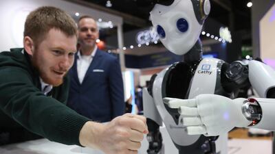 An attendee interacts with a humanoid robot called 'Cathy' on the CloudMinds Technology stand on day two of the MWC. Bloomberg