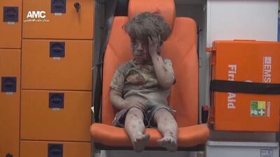 Omar Daqneesh sits in an ambulance after an airstrike hit a house in Aleppo. EPA
