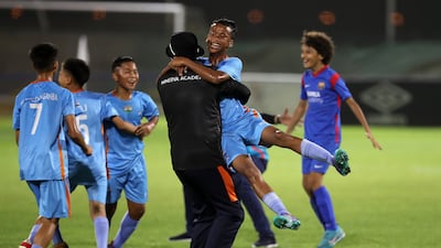 Player of Minerva Academy celebrate winning the U12 Mina Cup final.