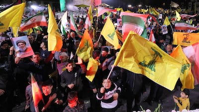 Demonstrators wave the flags of Iran and Hezbollah during a rally in Tehran, after the assassination of the group's leader, Hassan Nasrallah. AFP
