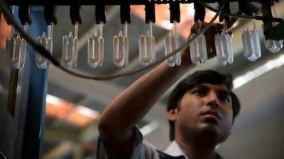 A worker checks burners at the Starlite Lighting Ltd factory in Nasik, Maharashtra state, India. Indian manufacturing growth slowed in May, a survey showed, adding to signs of weakening demand after economic expansion moderated to a nine-year low.