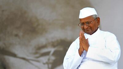 Anti-corruption activist Anna Hazare gestures to supporters as he walks on-stage to break his fast on the 13th day of his hunger strike at the Ram Lila grounds in New Delhi, on August 28, 2011. Indian hunger-striker Anna Hazare, who has led a campaign for???