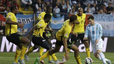 Surrounded by Jamaican players, Argentina's Lionel Messi controls the ball during a Copa America Group B soccer match at the Sausalito Stadium in Vina del Mar, Chile, Saturday, June 20, 2015. AP Photo