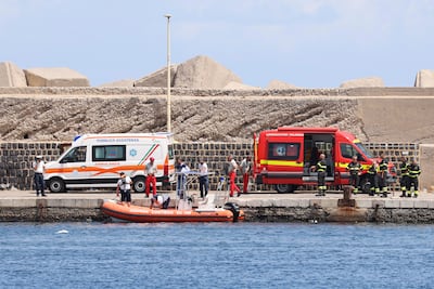 Emergency services at the scene of the search for the stricken yacht, in Porticello, Sicily. AP