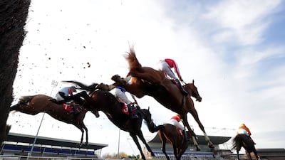 Captain Blackpearl ridden by jockey Ciaran Gethings (nearside) clears a fence on the way to winning the racingtv.com Novices' Handicap Chase at Kempton Park Racecourse in England on Monday November 9. PA