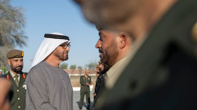 President Sheikh Mohamed greets a member of the UAE Armed Forces during the ceremony at Abu Mreikhah