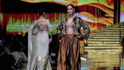 Models present creation of a designers Asifa & Nabeel during the Bridal Couture Week' fashion show, in Lahore, Pakistan. AP
