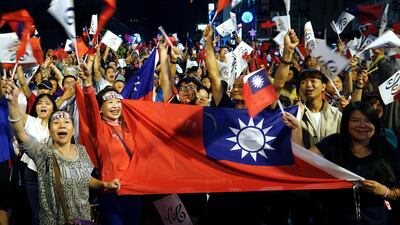 Supporters of the opposition Nationalist Party cheer in Kaohsiung, Taiwan. China says it will not "renounce the use of force" in efforts to reunify Taiwan with the mainland and vows to take all necessary military measures to defeat "separatists". AP