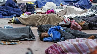 Central American migrants travelling in the "Migrant Via Crucis" caravan sleep outside "El Chaparral" port of entry to US while waiting to be received by US authorities, in Tijuana, Baja California State, Mexico on April 30, 2018. Guillermo Arias / AFP