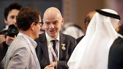 Uefa General Secretary and Fifa president candidate Gianni Infantino, centre, talks to Fabio Capello, left, before the opening session of Dubai International Sports Conference. Ali Haider / EPA