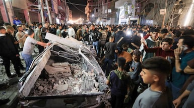 Palestinians gather at the site of an Israeli strike on Gaza city. Reuters
