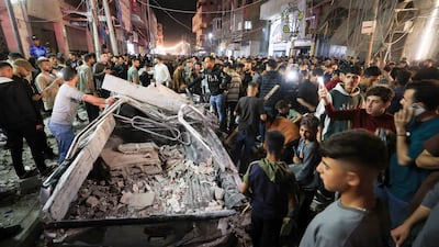 Palestinians gather at the site of an Israeli strike on Gaza city. Reuters