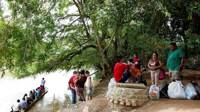 People wait their turn to cross to Boca del Grita in Venezuela from Puerto Santander, Colombia, carrying goods they desperately need and struggle to get at home. Carlos Garcia Rawlins/Reuters