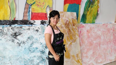 Verano Field, an artist with special needs who paints using dance, movement and music, shows her work at the Mawaheb studio in Al Quoz, Dubai. Pawan Singh / The National
