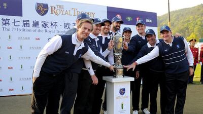 Team Europe pose with the Royal Trophy after coming back to defeat Asia on Sunday. Khalid Redza / AFP