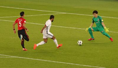 Al Jazira’s Ali Mabkhout scores past the Urawa Red Diamonds goalkeeper. Ahmed Jadallah / Reuters
