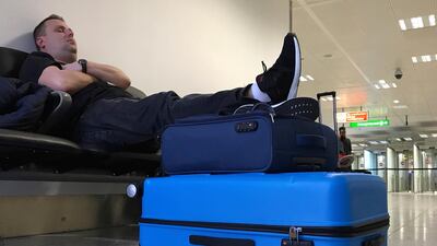 A passenger waits at Gatwick Airport. AP Photo